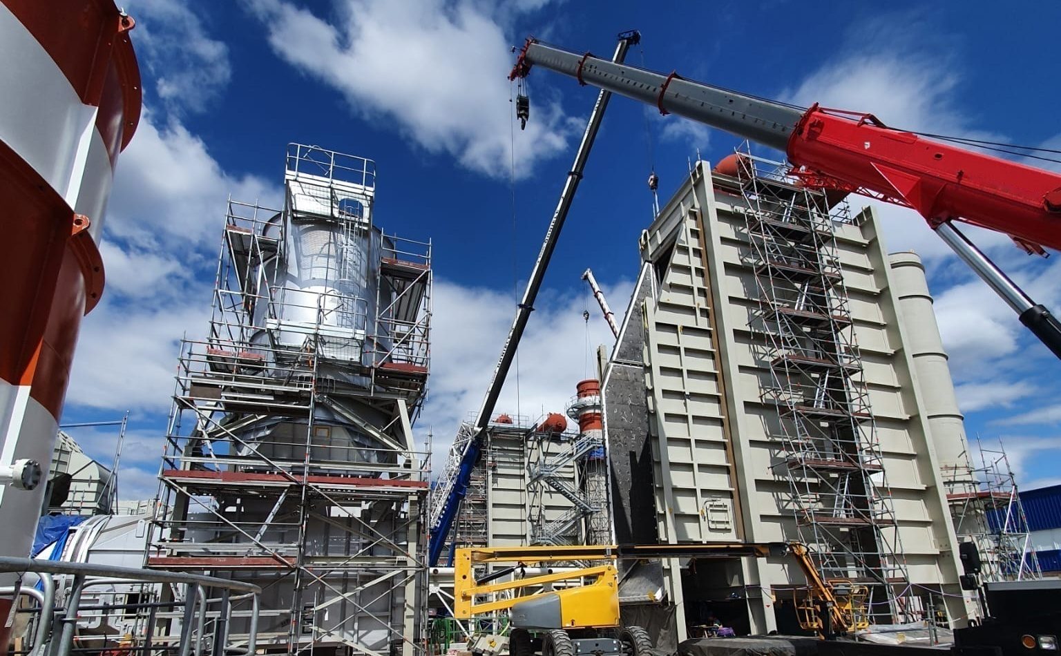 Plant under construction, crane lifting components