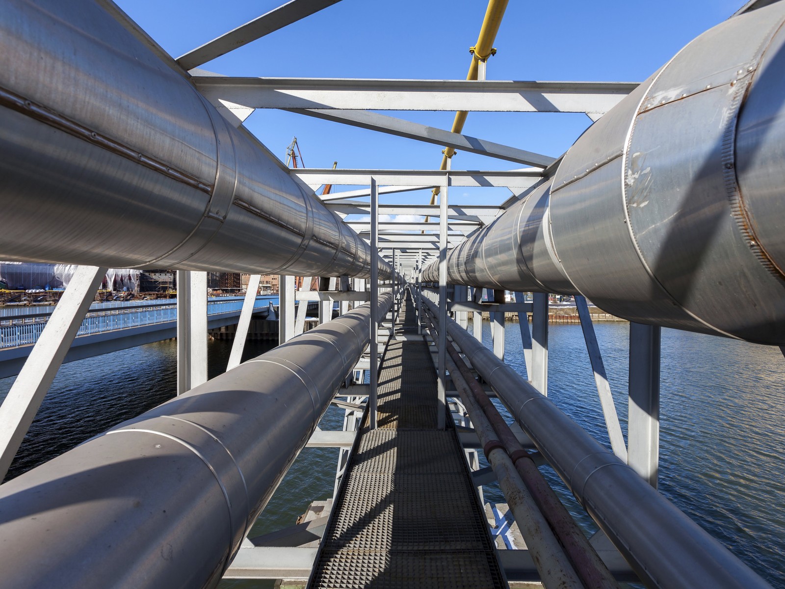 Insulated pipelines on a pipe bridge over the water