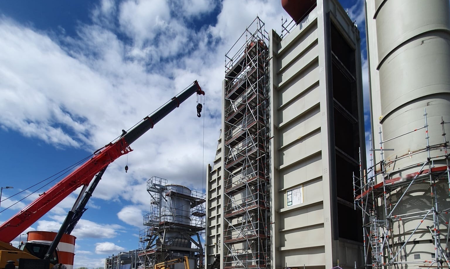 Power plant under construction with crane and scaffolding